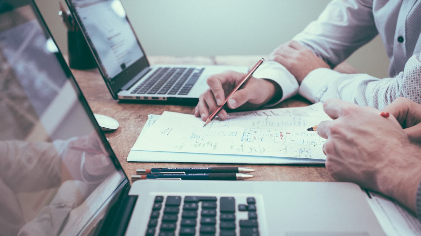 Documents and a laptop used for reviewing advertising budget decisions